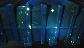Sample photos of indications obtained using a fluorescent penetrant. Sample photos of indications obtained using a fluorescent penetrant.